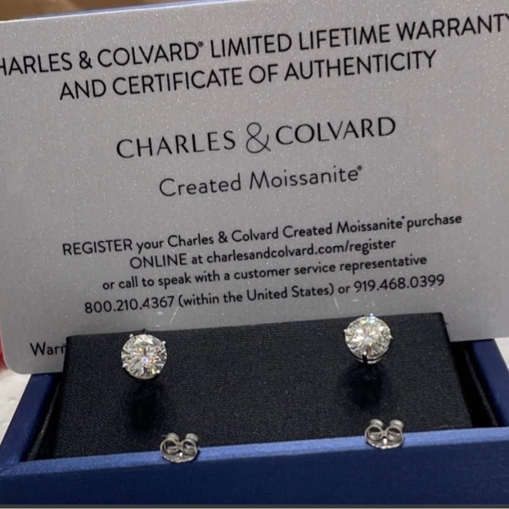 1ct ea Charles Colvard earrings mounted in 14k white gold.